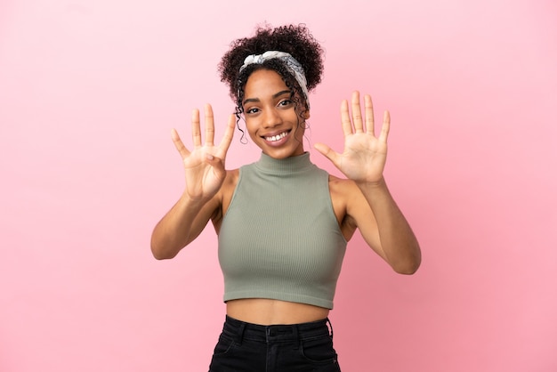 Young latin woman isolated on pink background counting nine with fingers