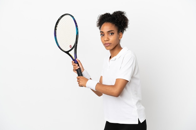 Young latin woman isolated on white background playing tennis