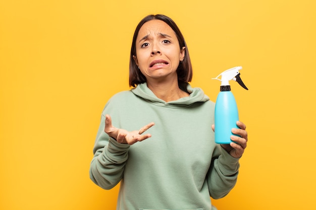 Young latin woman looking desperate and frustrated, stressed, unhappy and annoyed, shouting and screaming