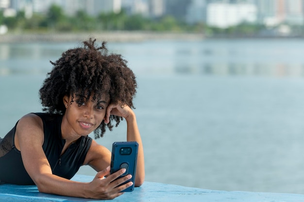 A young latin woman smiling with a smartphone in Panama city Panama Central America