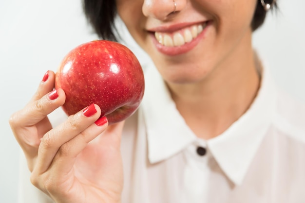 Young latina woman smile white teeth with apple in mouth diet white teeth