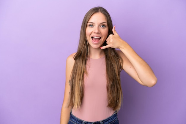 Young Lithuanian woman isolated on purple background making phone gesture. Call me back sign