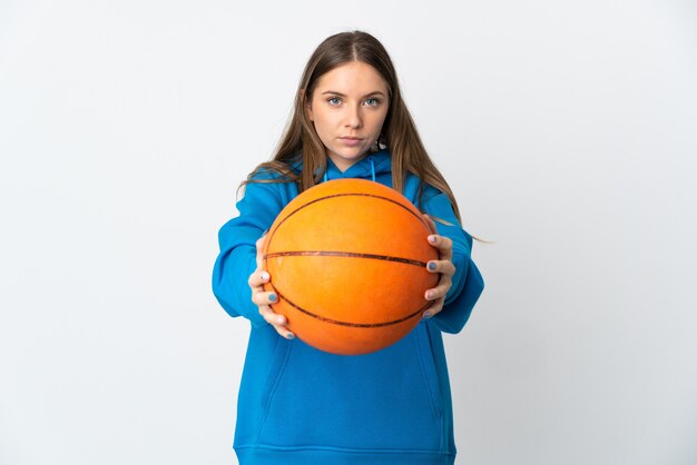 Young Lithuanian woman isolated on white background playing basketball