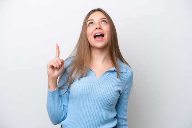 Young Lithuanian woman isolated on white background pointing up and surprised