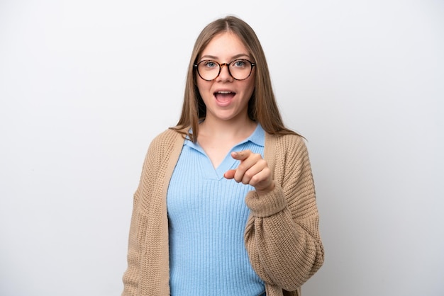 Young Lithuanian woman isolated on white background surprised and pointing front