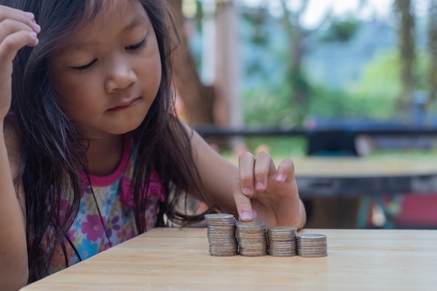 Young little girl looking at coins