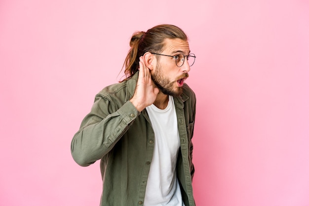 Young long hair caucasian handsome man expressing emotions isolated