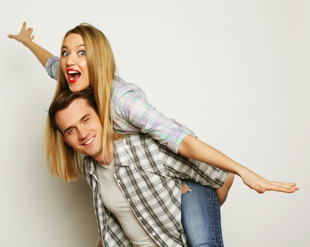 Young lovely couple posing in studio, close up, happy man and happy woman,