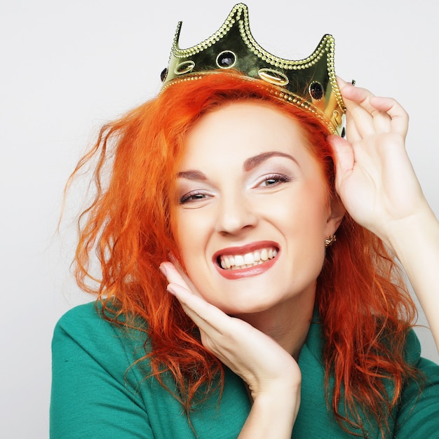 Young lovely redhair woman in crown