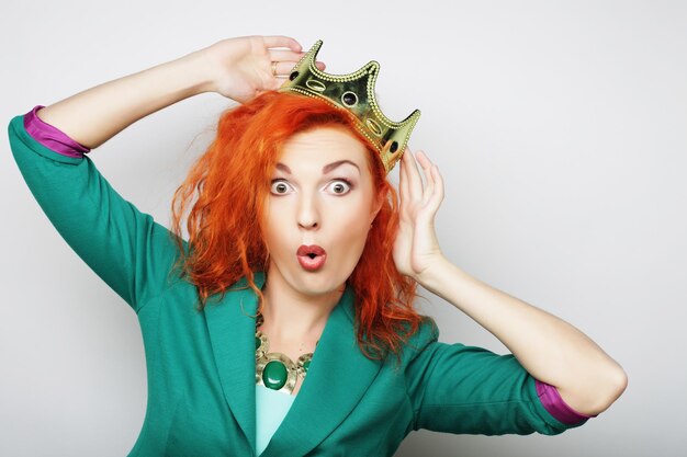 Young lovely redhair woman in crown