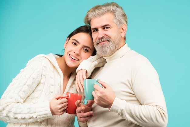 Young lovers hugging and embracing with mug cup couple in love tenderness and affection