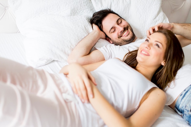 Young loving couple in the bed