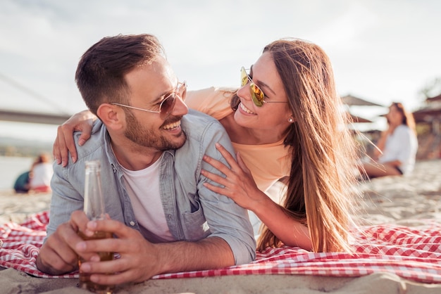 Young loving happy couple have fun on the beach