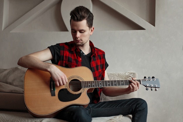 Young male artist playing the guitar