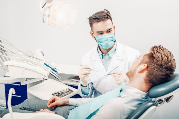 A young male dentist and a patient