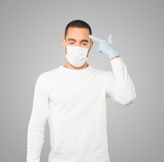 Young male doctor wearing mask and protective gloves