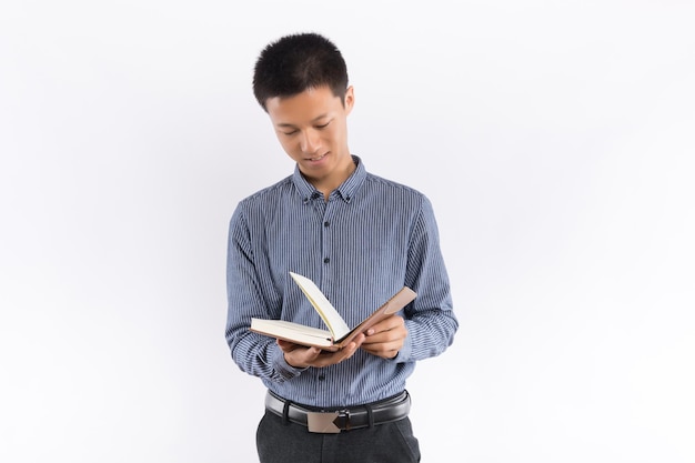 Young male hands holding notepad standing in front of white background