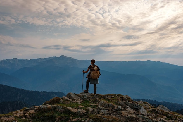 Young male hipster in the mountains in autumn