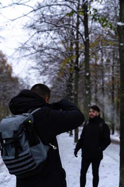 Young male photographer taking a picture of a model or tourists in the Tiergarten park in Berlin