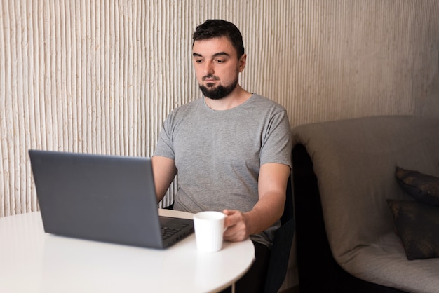 Young male professional using computer at home