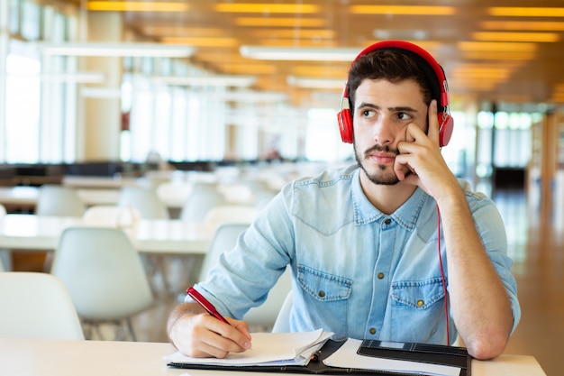 Young male student studying in the library.