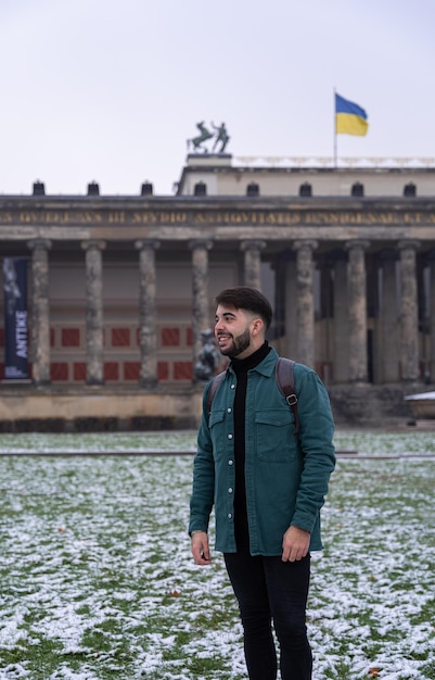 Young male tourist visiting Berlin in front of historical monument