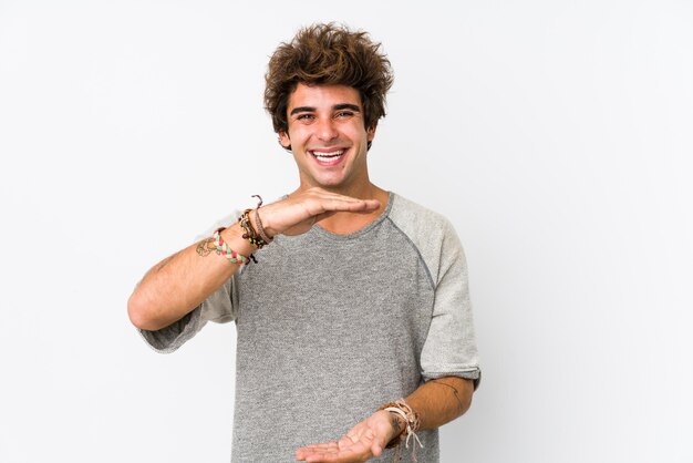 Young man against a white holding something with both hands, product presentation.