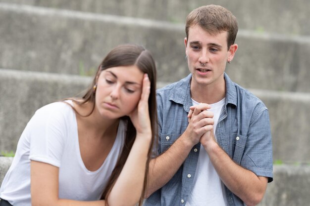 Young man asking for forgiveness to girlfriend. Relationship problems concept