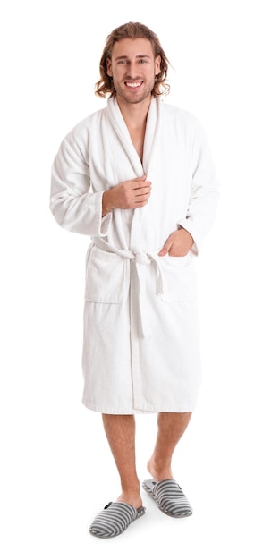 Young man in bathrobe on white background