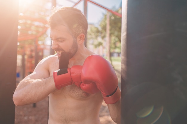 Young man boxing workout Boxer Exercise Athletic Boxing Concept boxer punch hand by punching bag