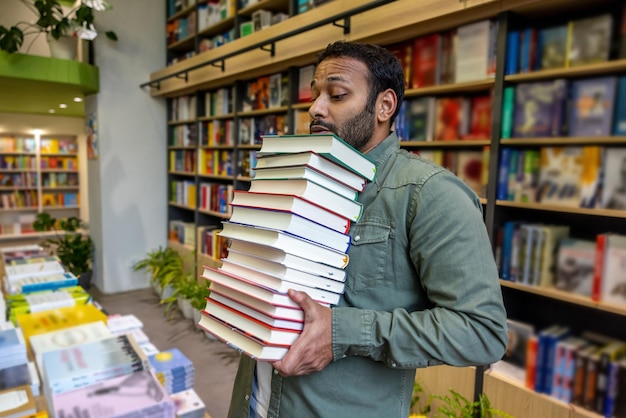 Young man carrying books