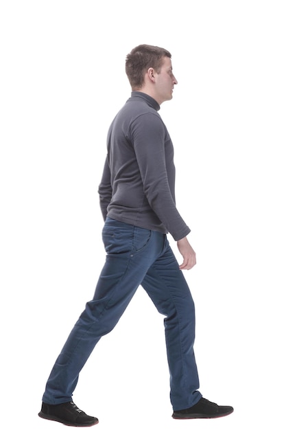 Young man in casual clothing striding forward