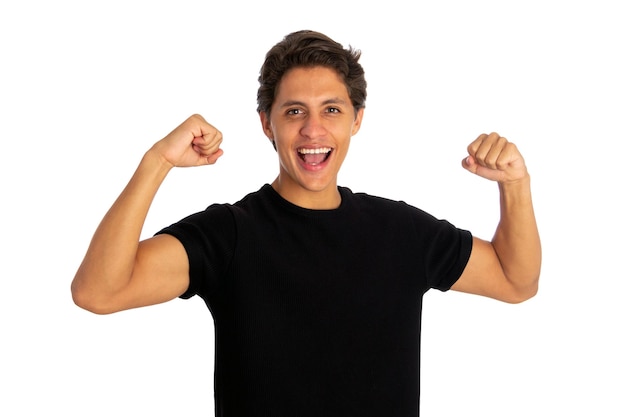 young man celebrating victory over white background