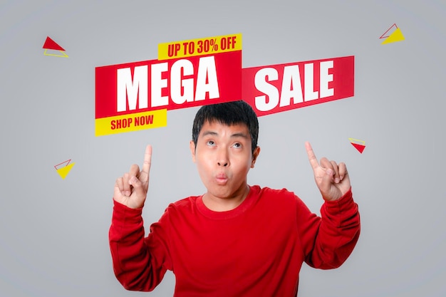 Young man of choosing screen MEGA SALE discount banner promotion isolated on gray background