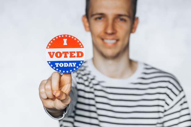 Photo young man citizen america holds i voted today sticker button united states 2020 isolated background