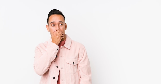 Young man covering mouth with hand