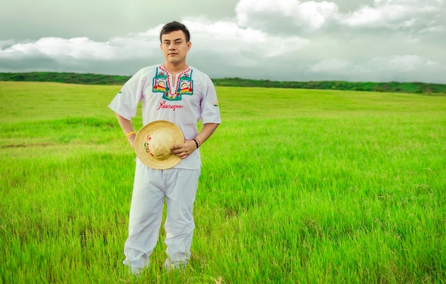 Young man in cultural and folk costume from Nicaragua Concept of man in Nicaraguan folk costume Nicaraguan man in folk costume in the field Man wearing Central American folk costume