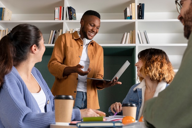 Young man discussing with his colleagues during study session