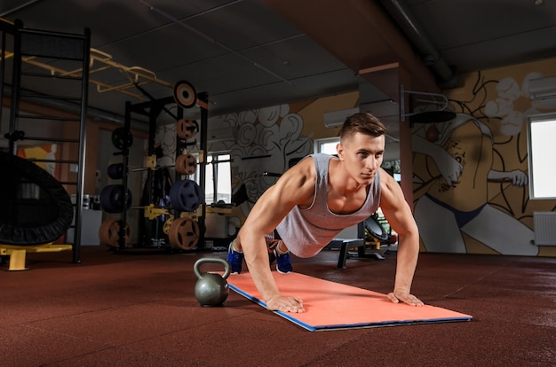 Young man doing exercises in the gym