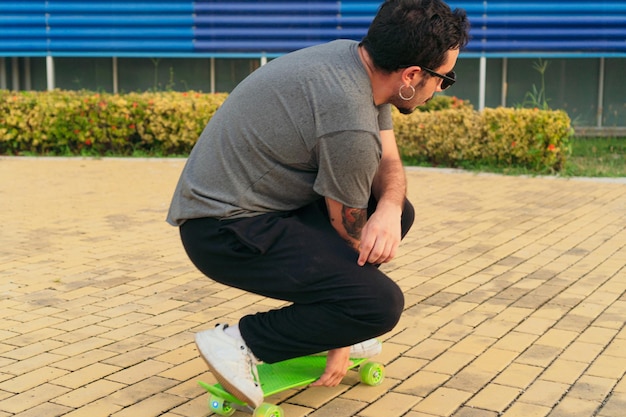 A young man doing tricks on his skateboard in the park