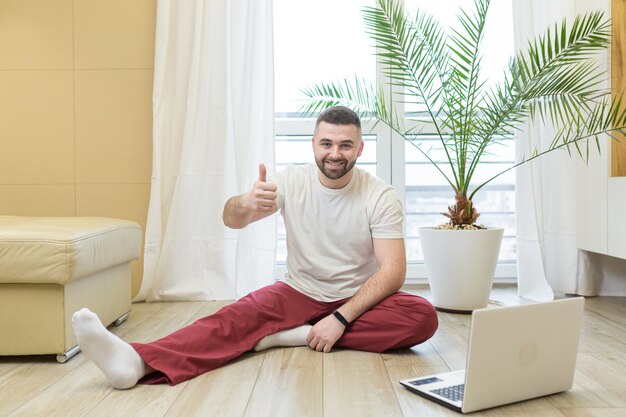 Young man doing yoga at home