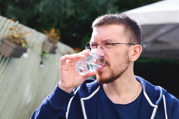 Young man drinking fresh water