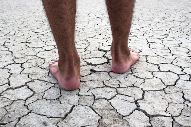 Young man on dry soil