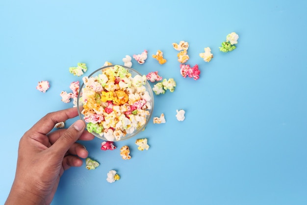 Young man eating popcorn top view