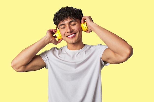 A young man enjoys his favorite tunes in highquality sound using wireless headphones