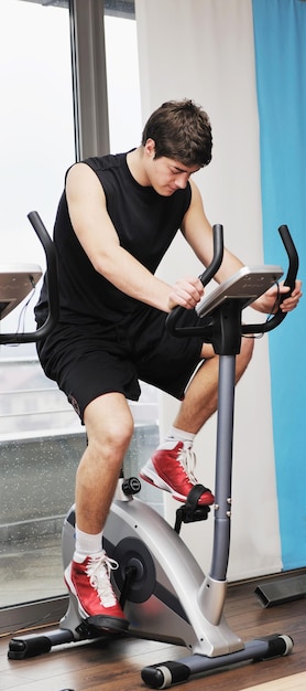 young man in fintess sport club exercise withweights and relaxing