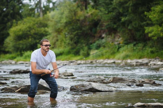 Young man fishing in a river