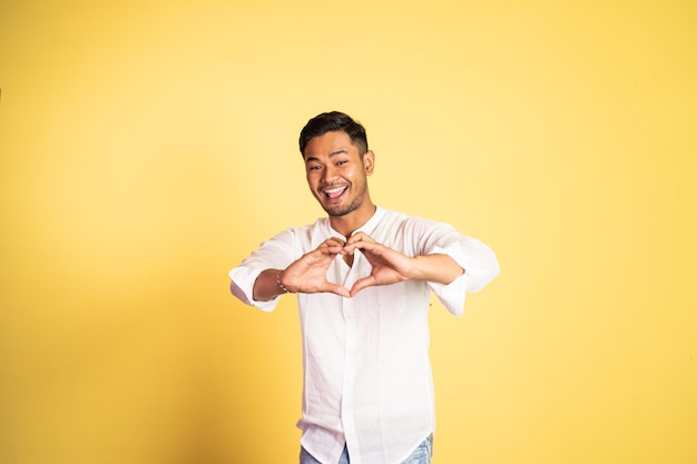 Young man forming a heart with finger gestures