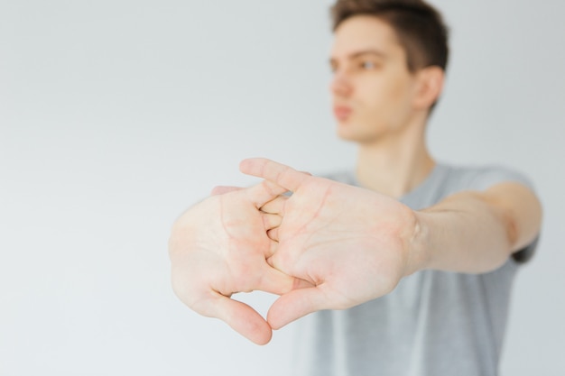 Young man goes in for sports at home. Sports activities at home