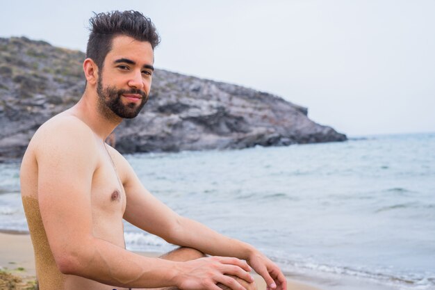 Young man happy on the beach